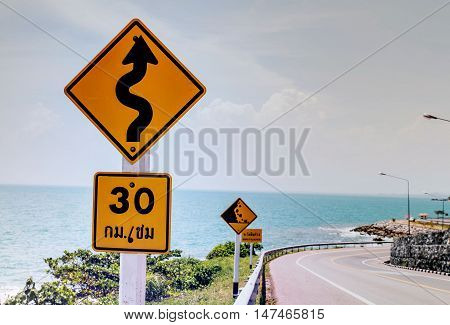 Bewarecurvy road sign should to drive 30km per hour