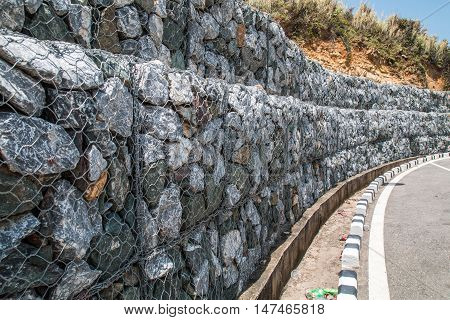 Stone wall along the road is long.