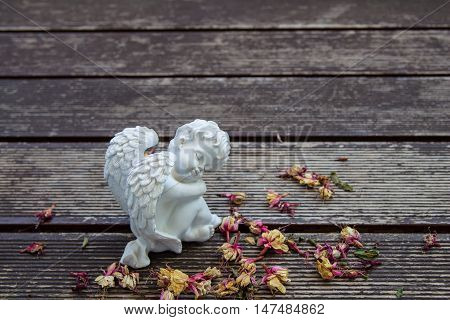 white angel sculture on the wood floor