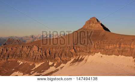 High mountain in the Swiss Alps. Mt Oldenhorn in summer. Golden evening light.