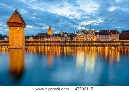 Night view towards Chapel Bridge (Kapellbruecke) together with the octagonal tall tower (Wasserturm) it is one of the Lucerne's most famous tourists attraction