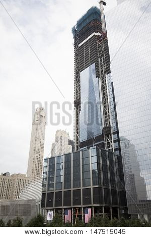 NEW YORK - SEPT 9 2016: Reflection of the Freedom Tower on the glass of the Tower 3 building at Three World Trade Center still under construction on the 15th anniversary of the terrorist attacks.