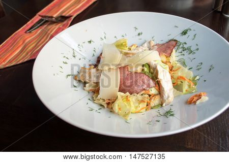 Delicious salad with chicken on the big plate