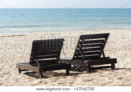 wooden beach chairs on beautiful island in white sand plage