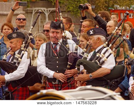 MOSCOW, RUSSIA - September 4, 2016: Bagpipers of Celtic pipes and drums band surrounded by townspeople in the Park of arts "Muzeon" on the Crimean embankment. Festival of military orchestras "Spasskaya Tower". September 4, 2016 in Moscow, Russia