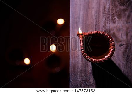 beautiful diwali diya with fire crackers and sweet pera, selective focus