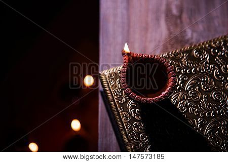 beautiful diwali diya with fire crackers and sweet pera, selective focus