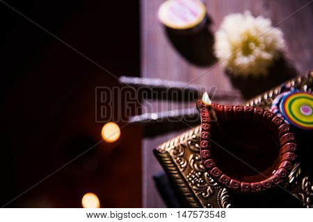 beautiful diwali diya with fire crackers and sweet pera, selective focus