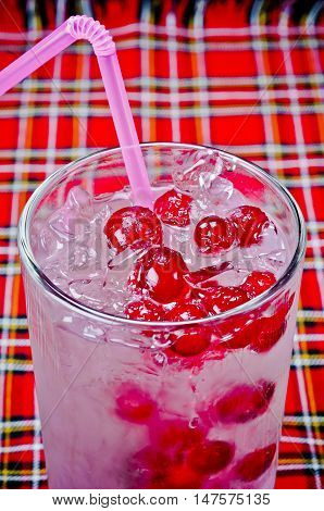 delicious cold refreshing summer cocktail with ice and red berries for the menu in restaurants bars cafes clubs