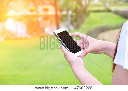 Women Using Mobile phone in the park Vintage Tone