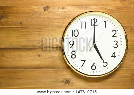 wall clock on the wooden wall at 5am or 5pm