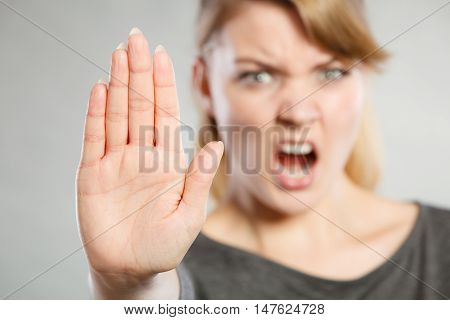Female Shows Stop Sign By Her Hand.