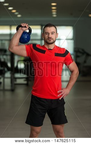 Personal Trainer Exercising With Kettle-bell