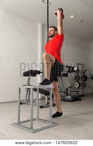 Fitness Instructor Doing Heavy Weight Exercise With Kettle-bell