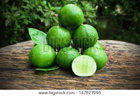 lemon with green leafs on wood background