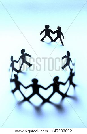 Paper dolls in circle with two bystanders