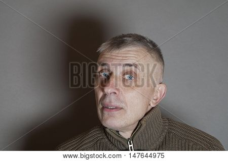 Cropped studio portrait of a man with a curious or surprised look