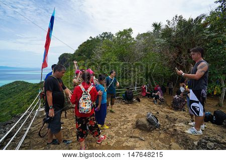 Semporna,Sabah-Sep 10,2016:Tourists enjoying amazing view from viewpoint National Park on top of Bohey Dulang island Semporna,Sabah.The bright blue water & rocky shore in the island of Semporna