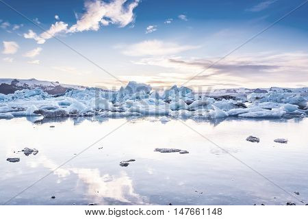 Scenic view of icebergs in Jokulsarlon glacier lagoon Iceland at sunset selective focus cool vintage style effect