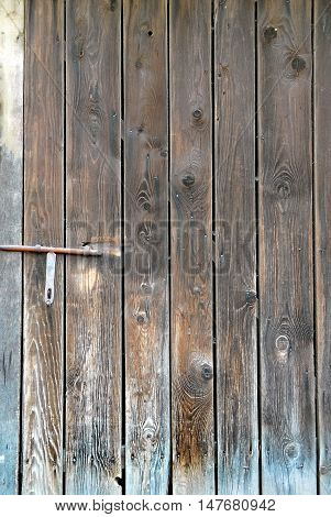 Old heck door of an ancient building. Backgrounds and textures