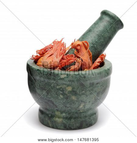 Organic Flower of Javitri or Mace (Myristica Fragrans) on marble pestle. Isolated on white background.