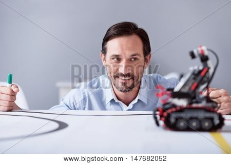 Happy day. Implementor being glad and satisfied while watching his new technical invention