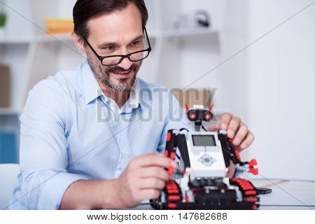 World of science. White man in glasses inventing technologies of future