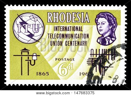RHODESIA - CIRCA 1965 : Cancelled postage stamp printed by Rhodesia, that shows ITU emblem and queen.