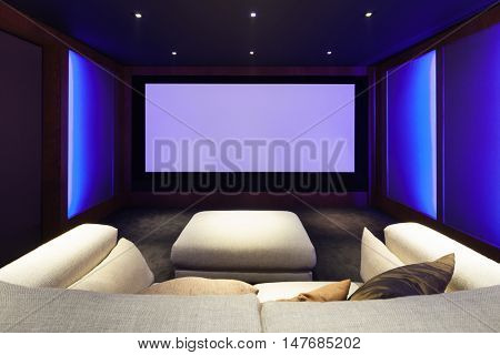 Home theater, luxury interior, comfortable divan and big screen