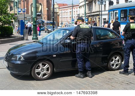 POLAND, KRAKOW - MAY 27, 2016: Polish guards of an order monitor in the historical part of Krakow.