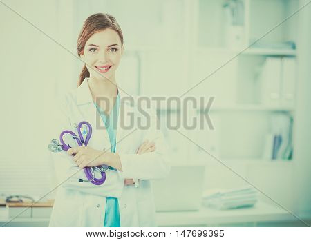 Portrait of happy successful young female doctor holding a stet