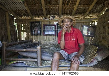 Ubud Bali Indonesia September 10th 2016: old man smoking a cigarette