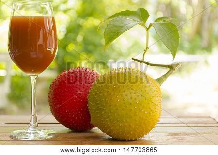 Green baby Jackfruit and juice on wooden background.fruit for health and stillife.001