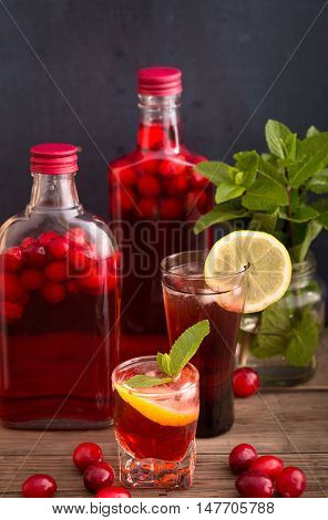 Shots and bottles of artisan cranberry alcoholic beverage