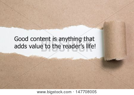 The quote Good content is anything that adds value to the readers life, appearing behind torn brown paper