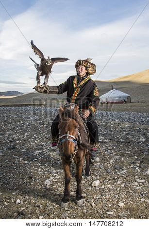 Bayan Ulgii Mongolia September 30th 2015: Mongolian eagle hunter with his eagle and horse