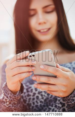 Young Pretty Model Using Modern Dual Camera Smart Phone