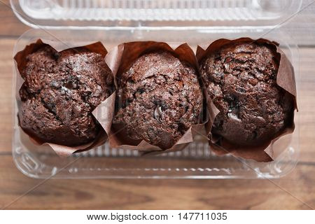 Three Chocolate Muffins In Plastic Container