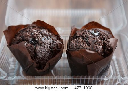 Two Chocolate Muffins In Plastic Food Container