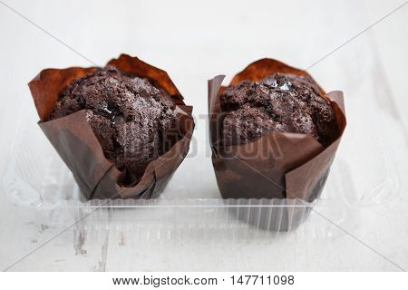 Two Chocolate Muffins In Plastic Food Container