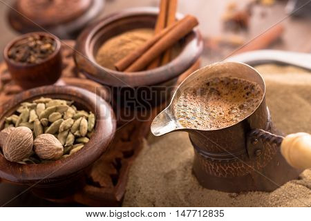 Coffee brewing in turkish pot and spices. Cezve
