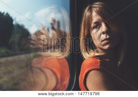 A woman in train alone and sad