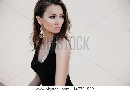 Professional photo shoot in desert. Beautiful sexy asian woman model in desert