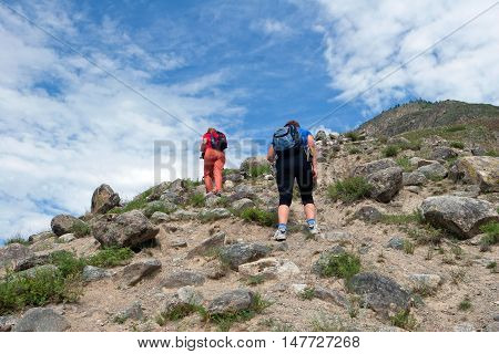 ALTAY, RUSSIA - JULY 18, 2007: Tourists walking in the Altay Mountains Russia.