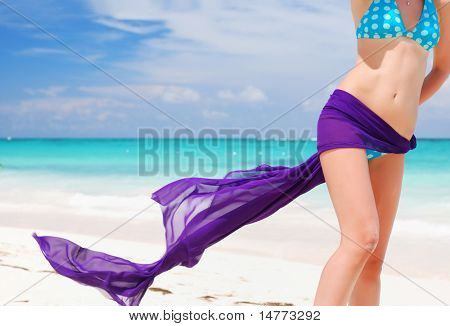Kvinde med sarong på caribisk strand