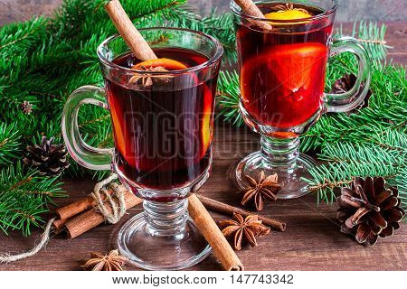hot spiced wine with christmas tree and pine cones. christmas drink
