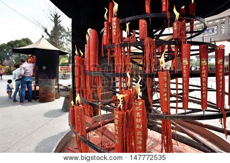 QIBAO CHINA - MARCH 20: Unidentified Chinese people pray in Qibao Temple on March 20 2016 in Shanghai China. Qibao is a historic scenic town located in Minhang District Shanghai China