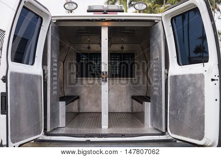 inside a police car. Open doors of a police van.