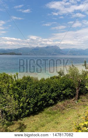 Landscape of the coast of Sirmione peninsula which divides the lower part of Lake Garda. It is a famous vacation place for a long time in northern Italy.