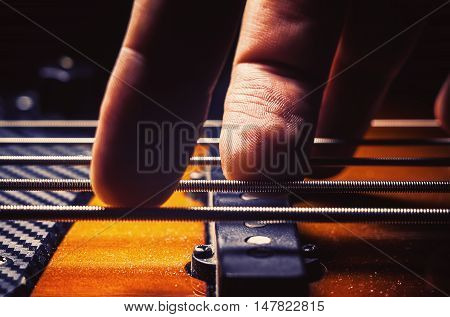 Male Fingers On A Bass Guitar